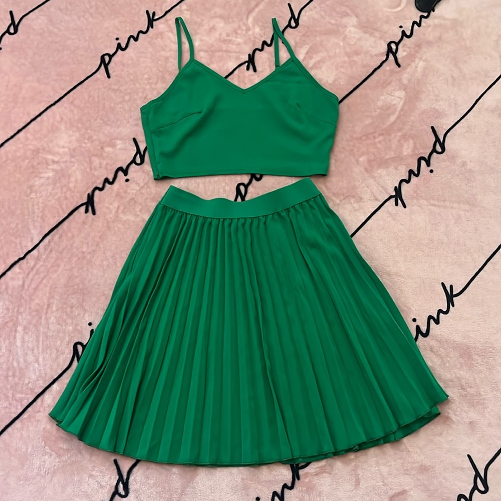 Green two piece top and pleaded skirt